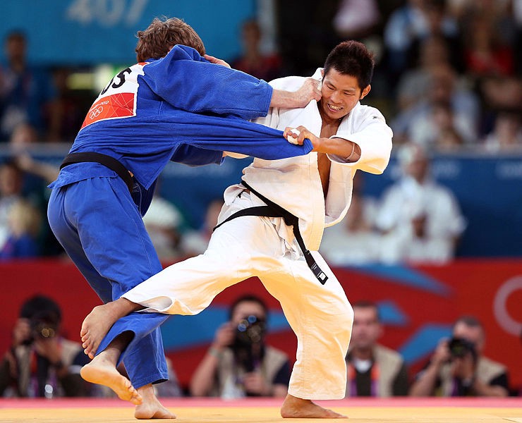 Judoka executing a throw in competition