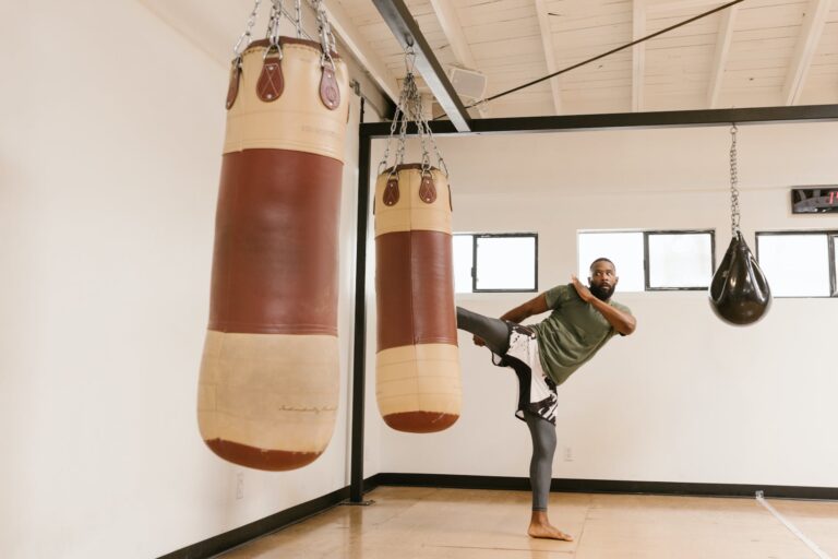 a man kicking the punching bag