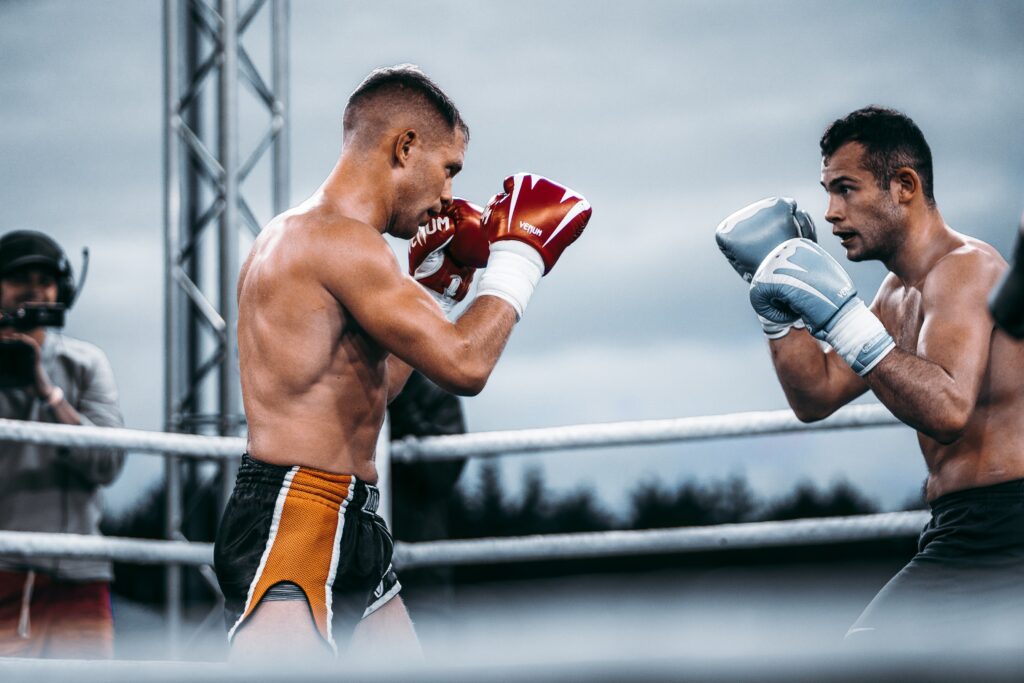 Two kickboxers standing inside the ring