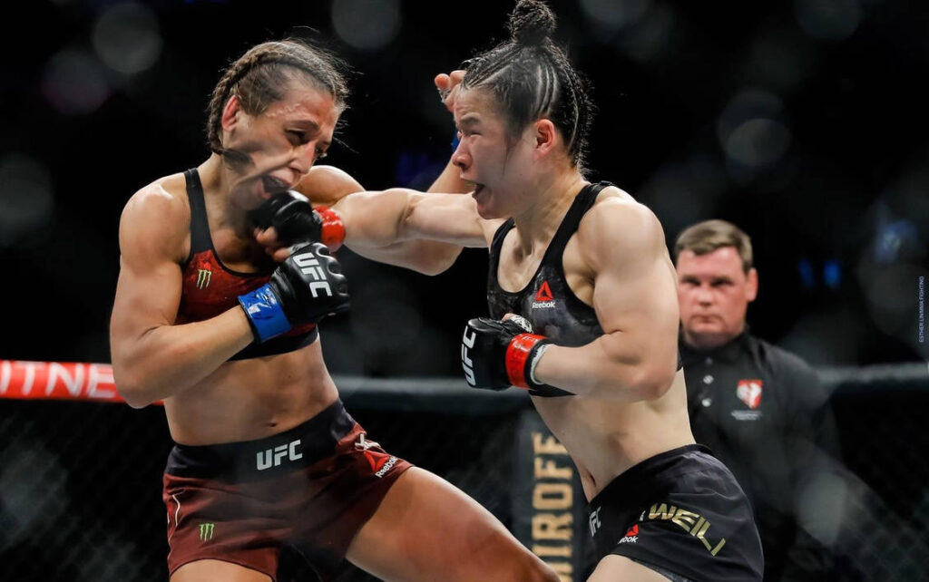 Joanna Jedrzejczyk absorbing a punch from Zhang Weili